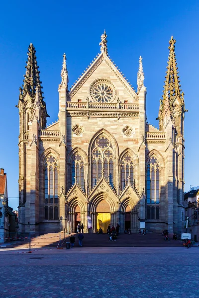 Gothic architectural structure against a blue sky in Alsace