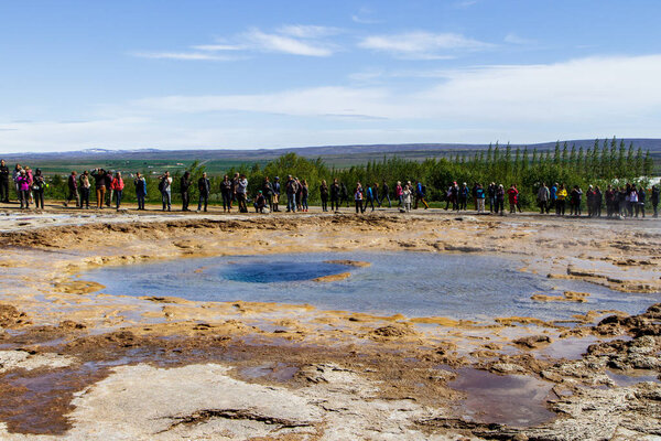 Tourists around a quiet geyser. The Golden Ring in Iceland 11.06,2017