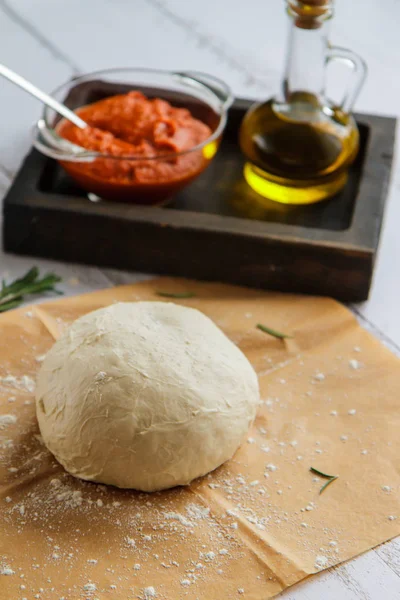 Bowl of raw dough on parchment and filling in a bowl