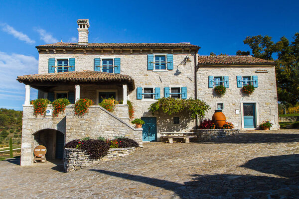 Beautiful old stone house with blue window. Croatia.