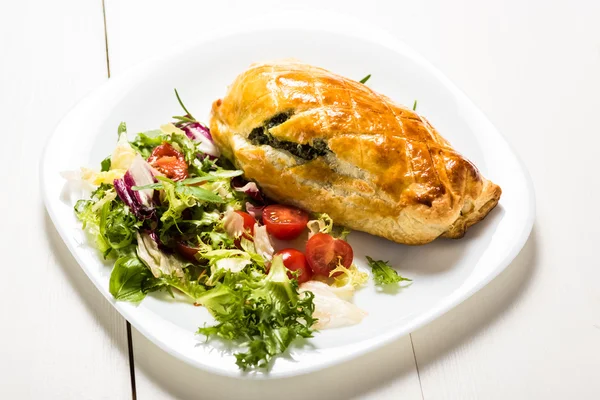 Chicken breast stuffed spinach in puff pastry — Stock Photo, Image