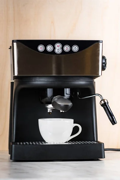 prepare a cup of coffee in espresso machine