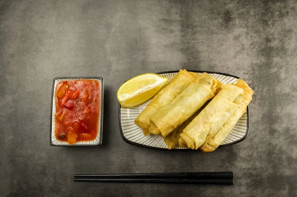 Spring rolls, chopsticks and sauce — Stock Photo, Image