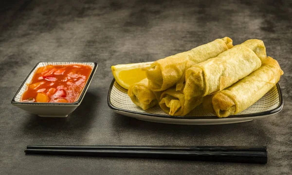 Spring rolls, chopsticks and sauce — Stock Photo, Image