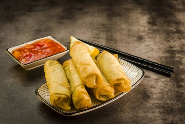 Spring rolls, chopsticks and sauce — Stock Photo, Image