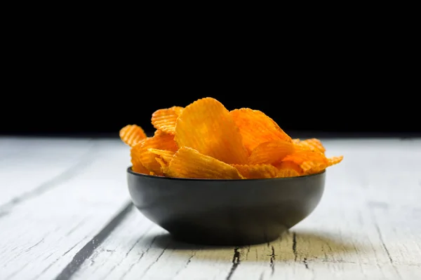 Bowl of chips on dark background — Stock Photo, Image