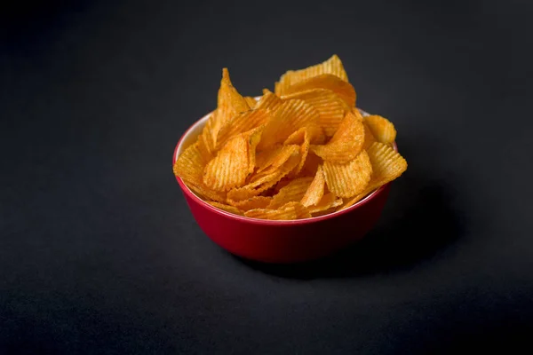 Bowl of chips on dark background — Stock Photo, Image