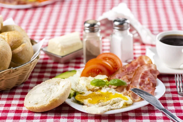 Bacon et oeufs avec avocat et tomate, pain et café — Photo