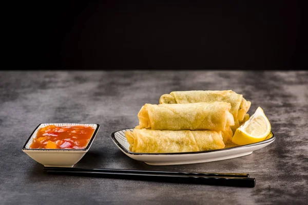 Spring rolls, chopsticks and sauce — Stock Photo, Image