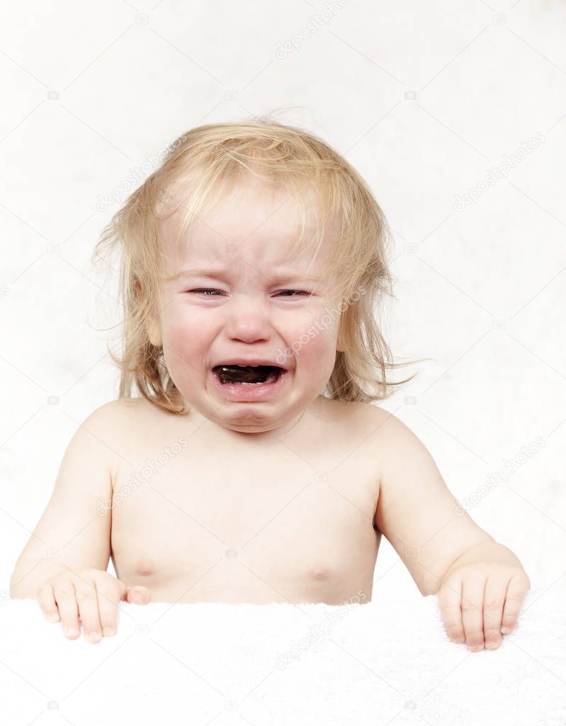 portrait of emotional tears crying baby toddler blond long hair