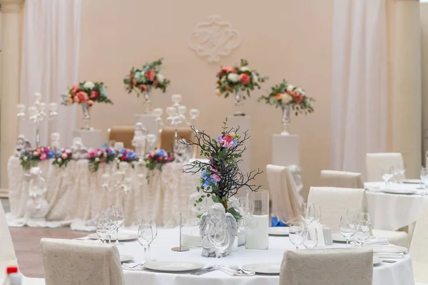 Wedding room tables decorated with flowers