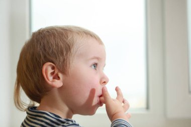 Komik bebek çocuk sarışın yalıyor parmak yoğurt ile