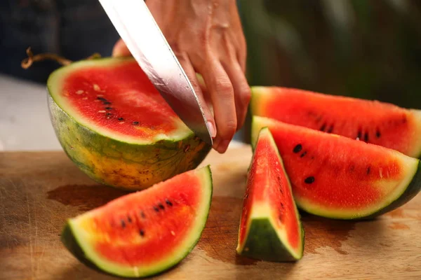 Women Cutting Fresh Ripe Watermelon Pieces Knife Wooden Table — Stock Photo, Image