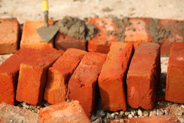 İnşaat sırasında toprak kanalında kırmızı tuğla. Tropikal Sri Lanka Tapınağı.