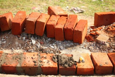 İnşaat sırasında toprak kanalında kırmızı tuğla. Tropikal Sri Lanka Tapınağı.