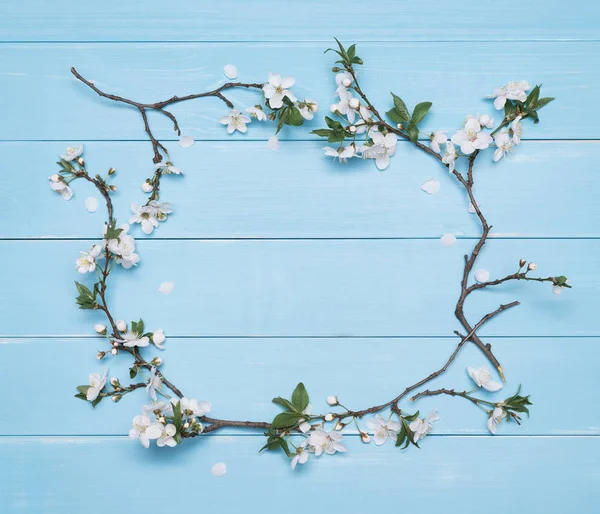 Flower frame on a blue wooden background — Stock Photo, Image