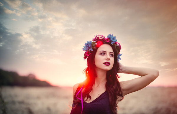 Portrait of a beautiful brunette woman with wreath in autumn outdoor