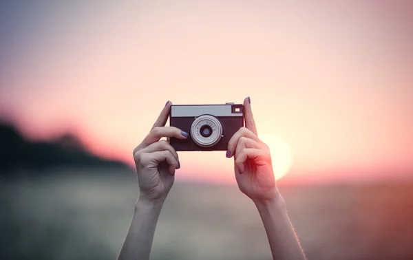 Mãos segurando uma câmera — Fotografia de Stock