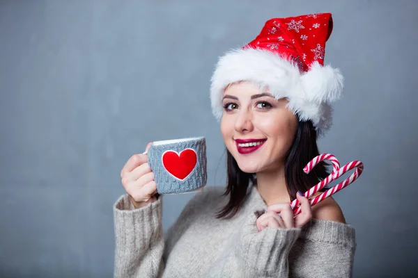 Woman with cup and lollipop — Stock Photo, Image