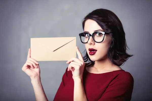 Woman in black dress with envelope — Stock Photo, Image