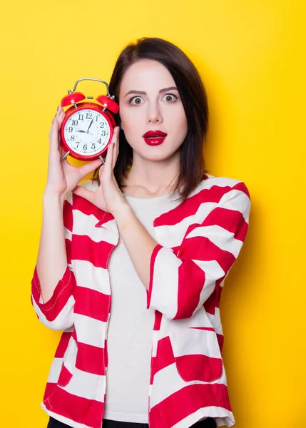 Brown hair girl with alarm clock — Stock Photo, Image