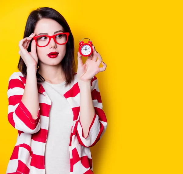 Woman in glasses with retro alarm clock — Stock Photo, Image