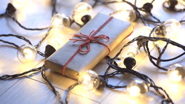 Christmas gift box and fairy lights — Stock Video