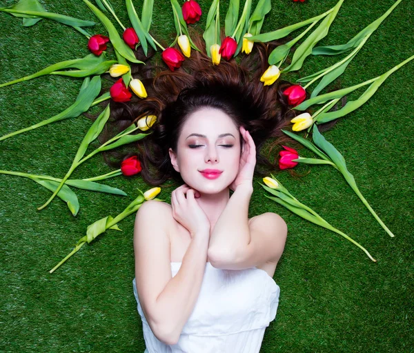 Portrait of a young redhead woman with tulips — Stock Photo, Image