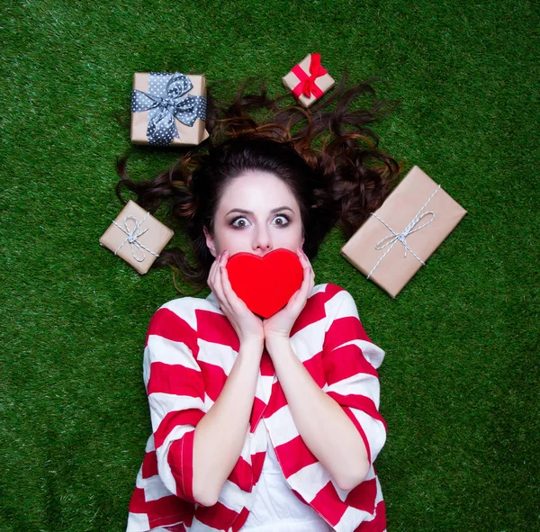 Portrait of a young styled redhead woman with heart shape gift a — Stock Photo, Image