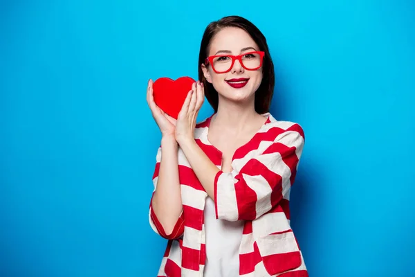 Smiling woman with heart shape box — Stock Photo, Image