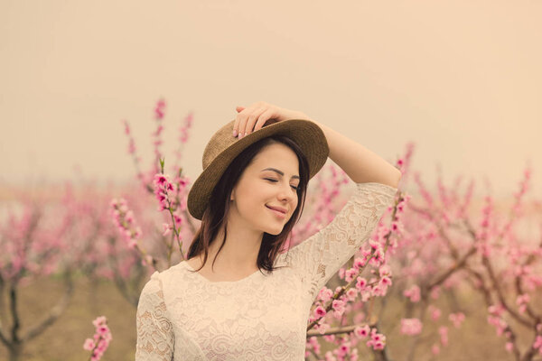 young woman in blooming garden 