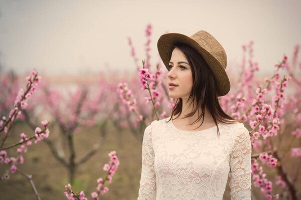 young woman in blooming garden 