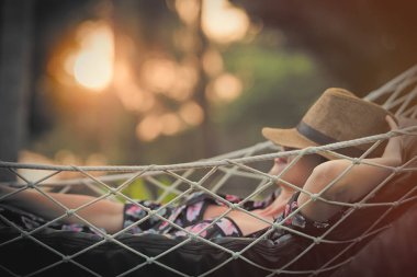 woman lying in hammock clipart