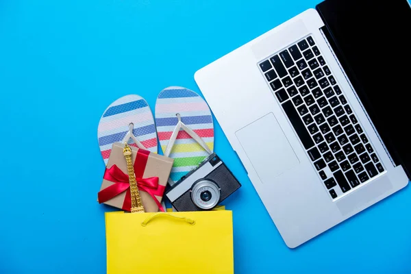 Sandals and gift in shopping bag — Stock Photo, Image