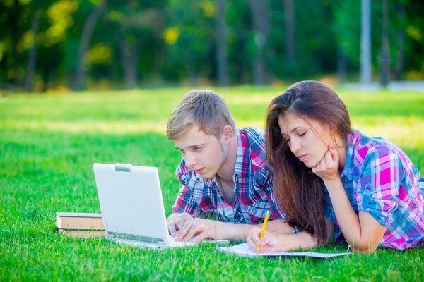 couple studing with books and laptop