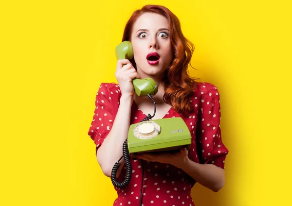 young woman with retro phone