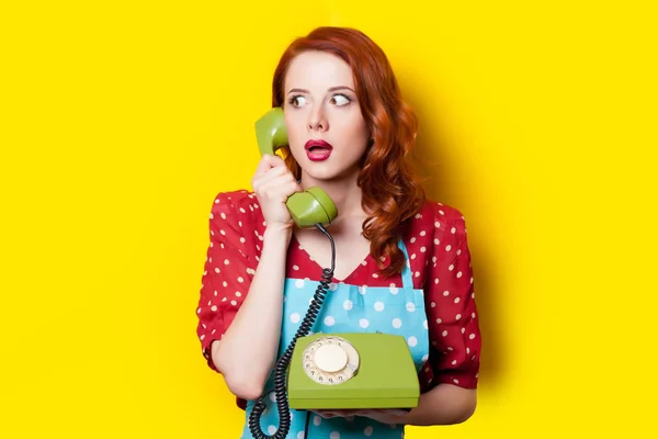 young woman with retro phone