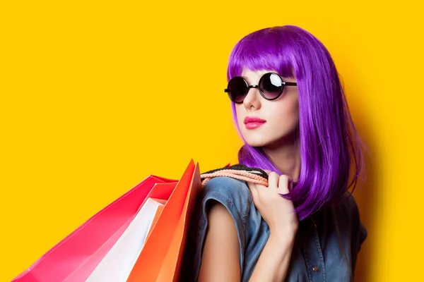 Photo of beautiful young woman in wig with shopping bags on the — Stock Photo, Image