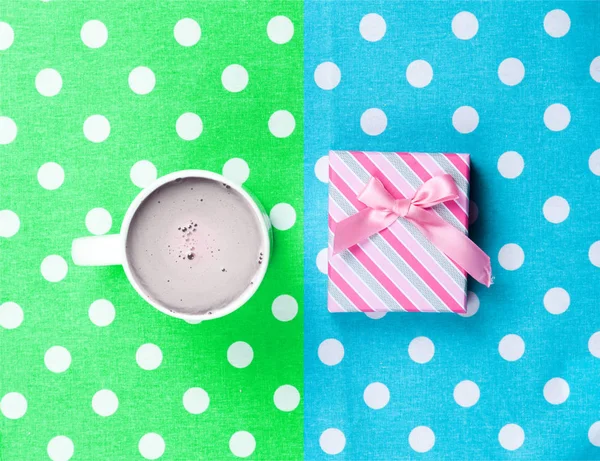 Cup of coffee and cute gift — Stock Photo, Image