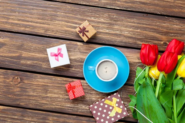 Cute gifts and cup of coffee — Stock Photo, Image