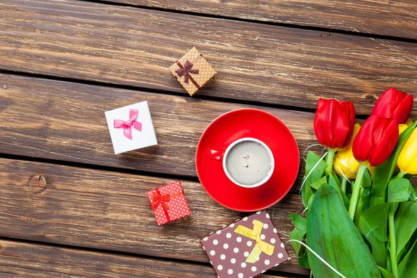 Cute gifts and cup of coffee — Stock Photo, Image