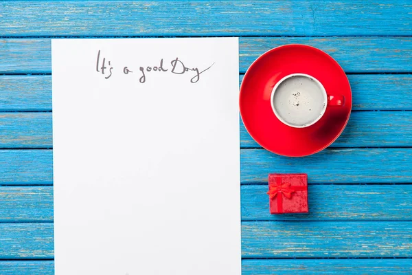 Cup of coffee and cute gift — Stock Photo, Image