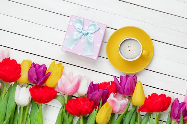 Cute gift and colorful tulips — Stock Photo, Image