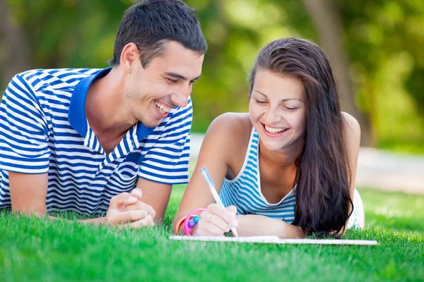 Cute couple lying on the grass — Stock Photo, Image