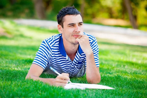 Man on the grass and thinking — Stock Photo, Image