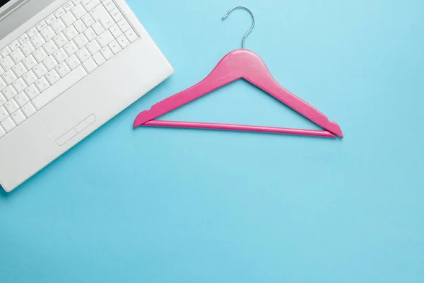 Wooden hanger and laptop — Stock Photo, Image
