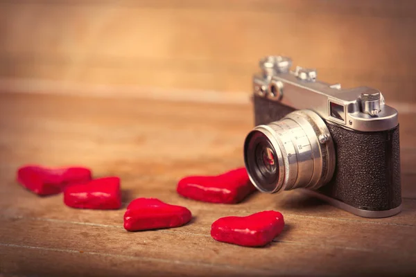 Heart shaped toys and retro camera — Stock Photo, Image