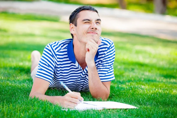 Man on the grass and thinking — Stock Photo, Image