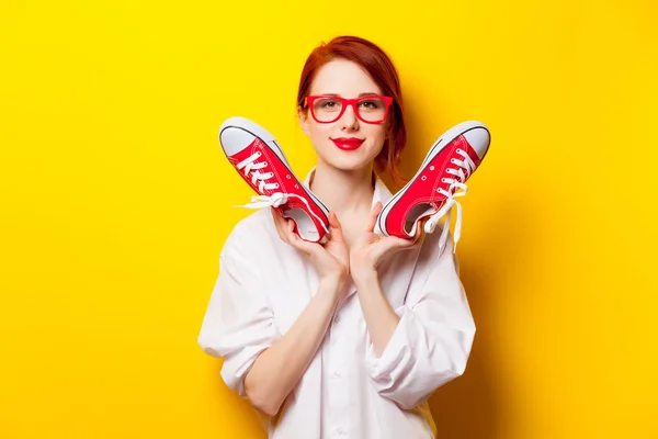 Photo of beautiful young woman holding gumshoes on the wonderful — Stock Photo, Image