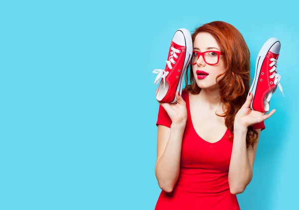 Photo of beautiful young woman with red gumshoes on the wonderfu — Stock Photo, Image